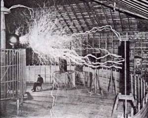 Tesla with his magnifying transmitter producing millions of volts of electricity